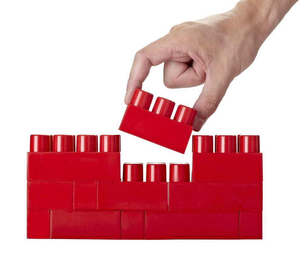 close up of child toy bricks construction on white background